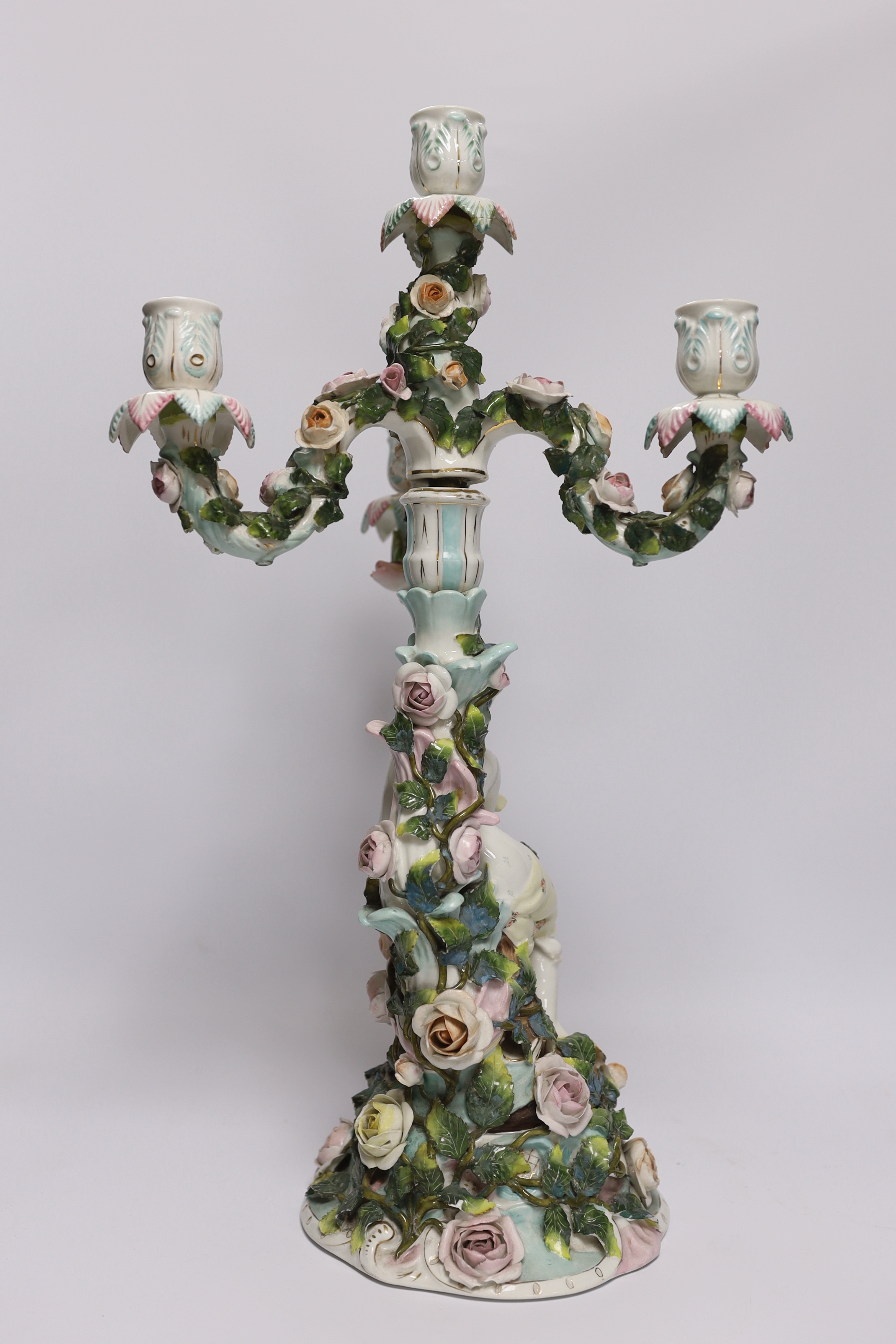 A 19th century Sitzendorf floral encrusted four light figural candelabra, 50cm